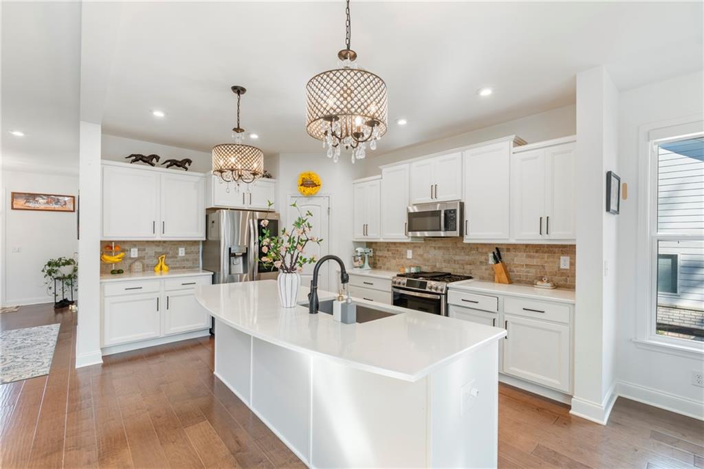 8110 Scenic Ridge Way Ball Ground, GA 30107 - Photo 2 of 29 a large kitchen with stainless steel appliances a stove oven and a refrigerator