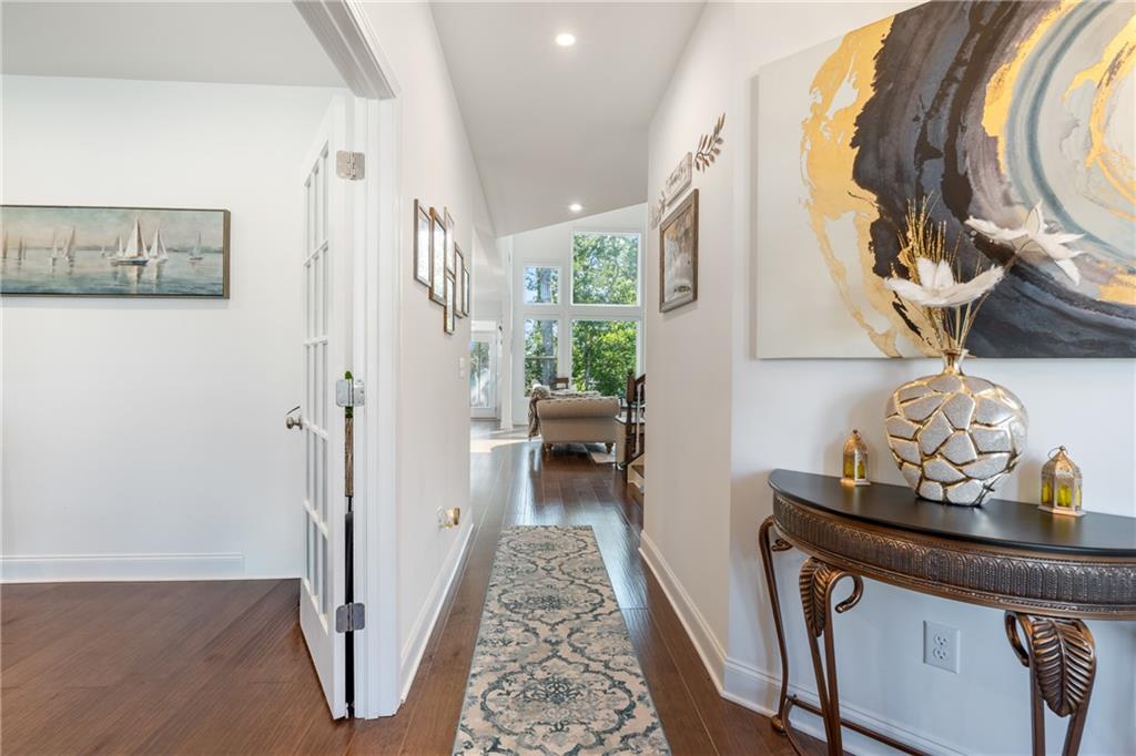 8110 Scenic Ridge Way Ball Ground, GA 30107 - Photo 5 of 29 a hallway with dining area and chandelier