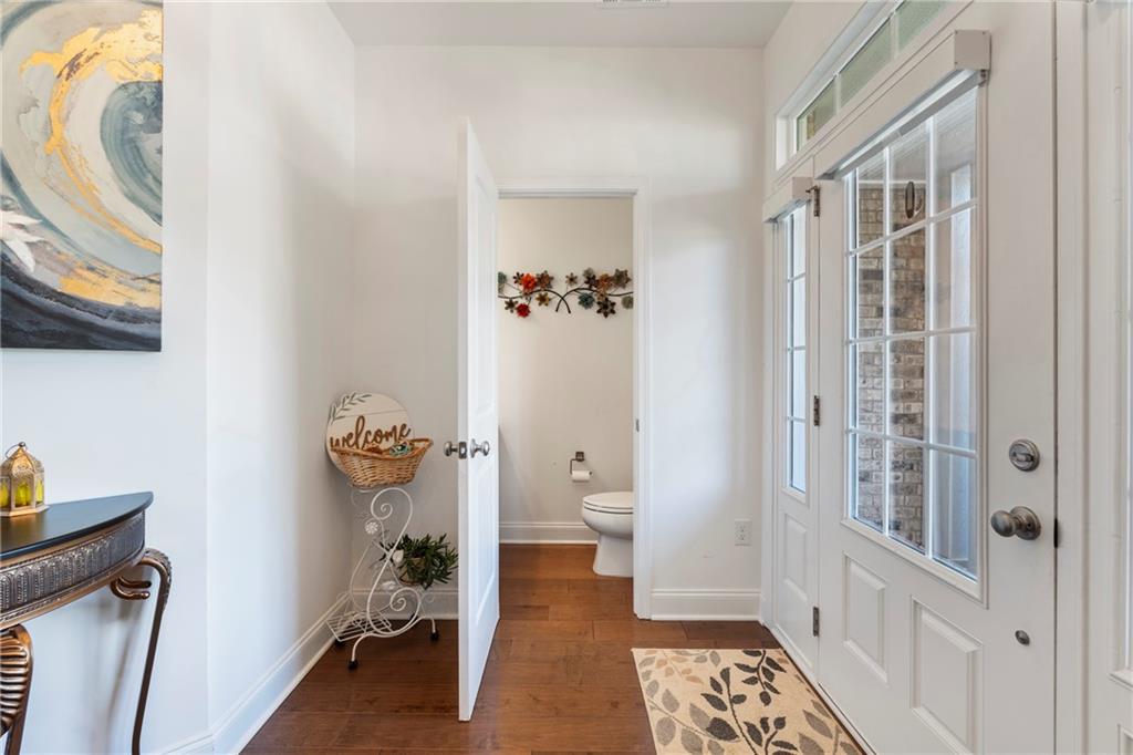 8110 Scenic Ridge Way Ball Ground, GA 30107 - Photo 6 of 29 a view of a hallway to rooms and wooden floor