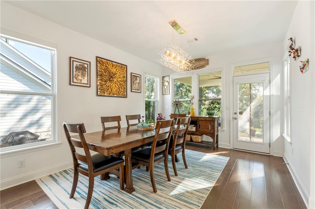 8110 Scenic Ridge Way Ball Ground, GA 30107 - Photo 10 of 29 a view of a dining room with furniture a chandelier and wooden floor