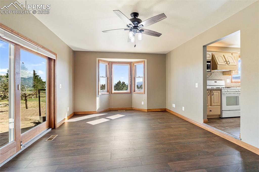725 Bowstring Road Monument, CO 80132 - Photo 18 of 50 wooden floor in an empty room with a window