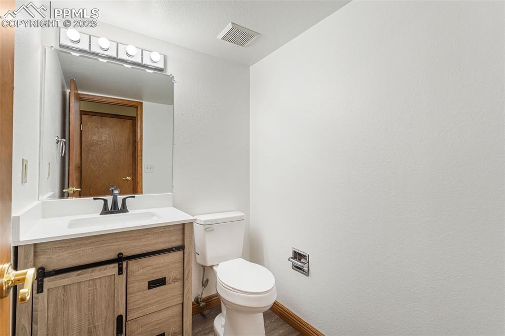 725 Bowstring Road Monument, CO 80132 - Photo 21 of 50 a bathroom with a toilet sink and mirror
