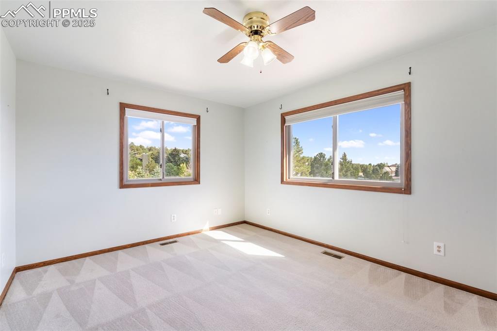 725 Bowstring Road Monument, CO 80132 - Photo 24 of 50 an empty room with windows and fan