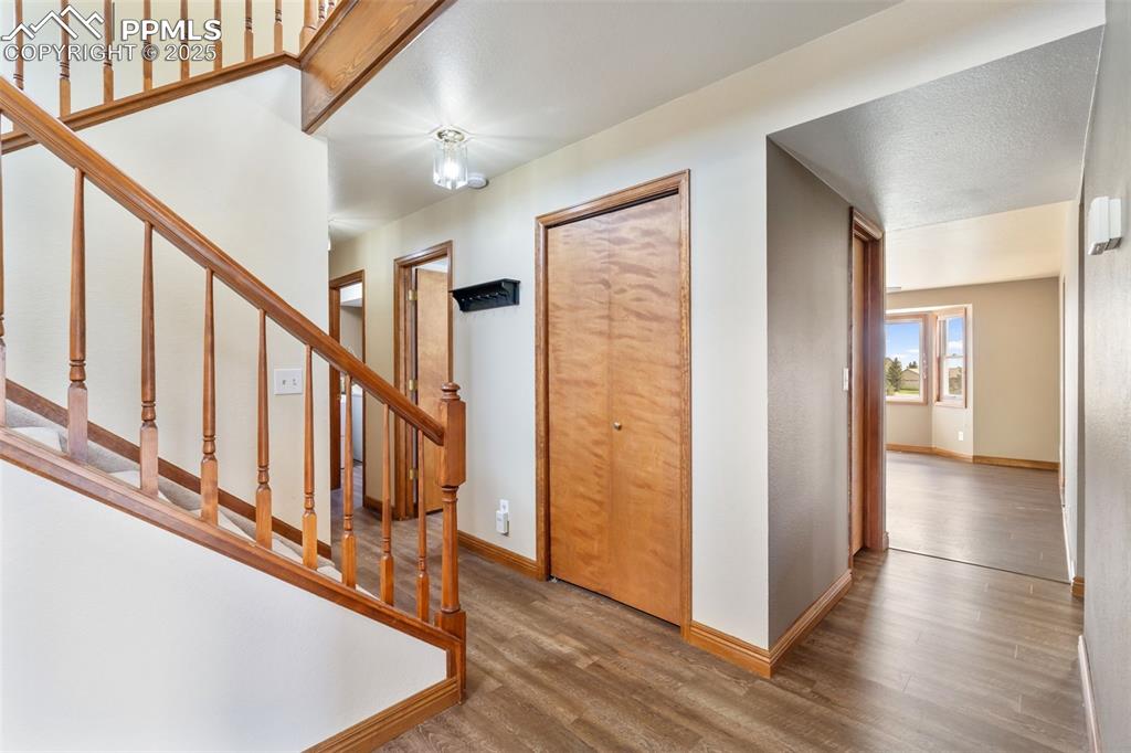 725 Bowstring Road Monument, CO 80132 - Photo 3 of 50 a view of an entryway with wooden floor and stairs