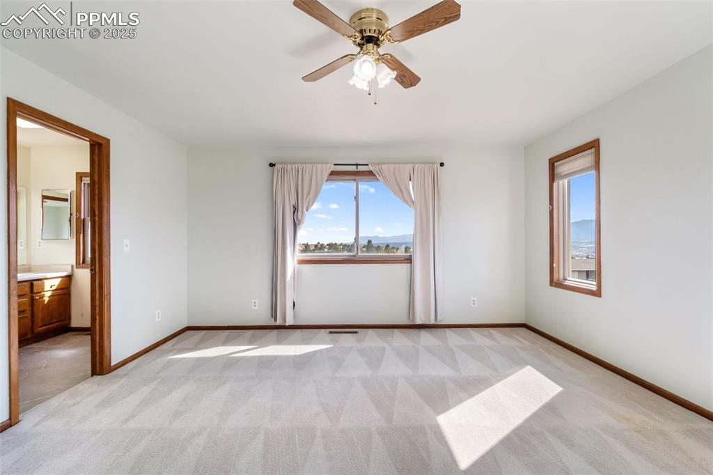 725 Bowstring Road Monument, CO 80132 - Photo 31 of 50 a view of a livingroom with a ceiling fan and window