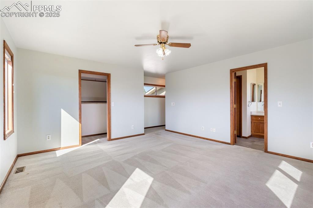 725 Bowstring Road Monument, CO 80132 - Photo 33 of 50 an empty room with closet and windows