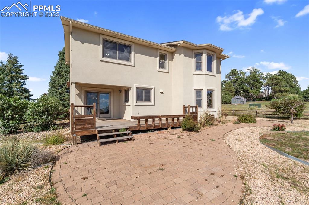 725 Bowstring Road Monument, CO 80132 - Photo 40 of 50 a view of a house with a yard