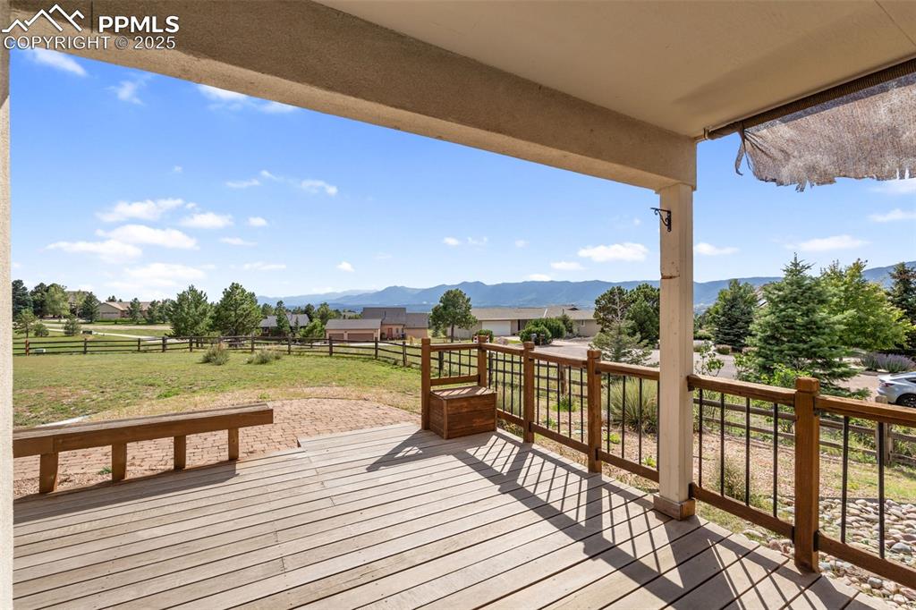 725 Bowstring Road Monument, CO 80132 - Photo 41 of 50 a view of a balcony with wooden floor next to a lake