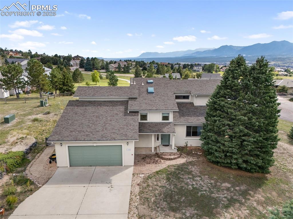 725 Bowstring Road Monument, CO 80132 - Photo 48 of 50 a aerial view of a house with a yard and large tree