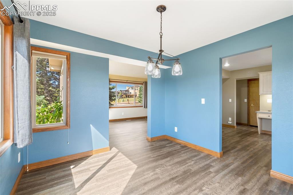 725 Bowstring Road Monument, CO 80132 - Photo 7 of 50 a view of a room with a window and wooden floor