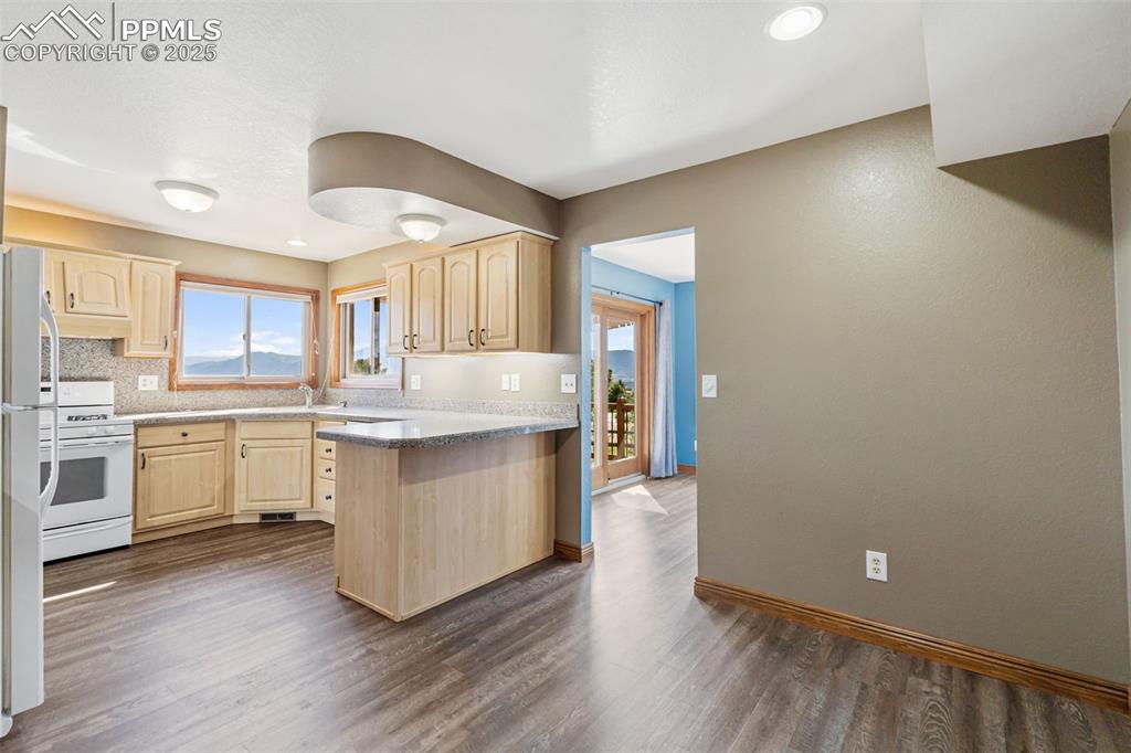 725 Bowstring Road Monument, CO 80132 - Photo 9 of 50 a kitchen with white cabinets and sink