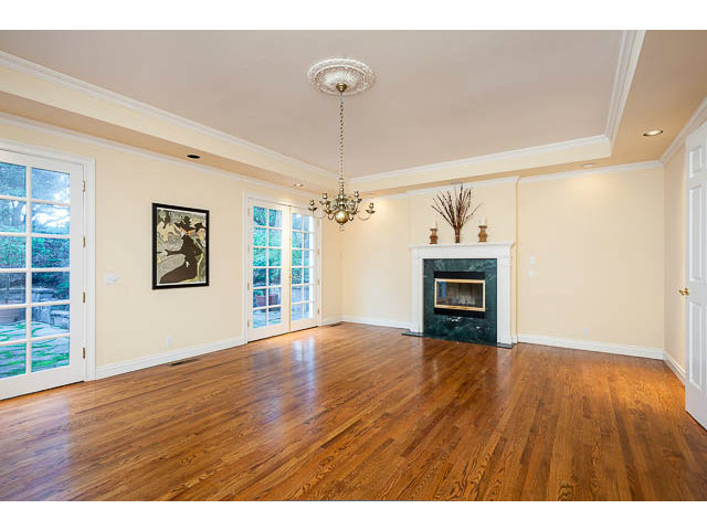 5070 Alpine Road Portola Valley, CA 94028 - Photo 7 of 15 a view of empty room with wooden floor fireplace and windows