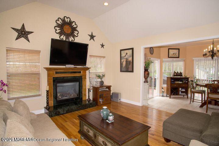 467 Leesville Road Jackson, NJ 08527 - Photo 7 of 19 a living room with furniture a flat screen tv and a fireplace