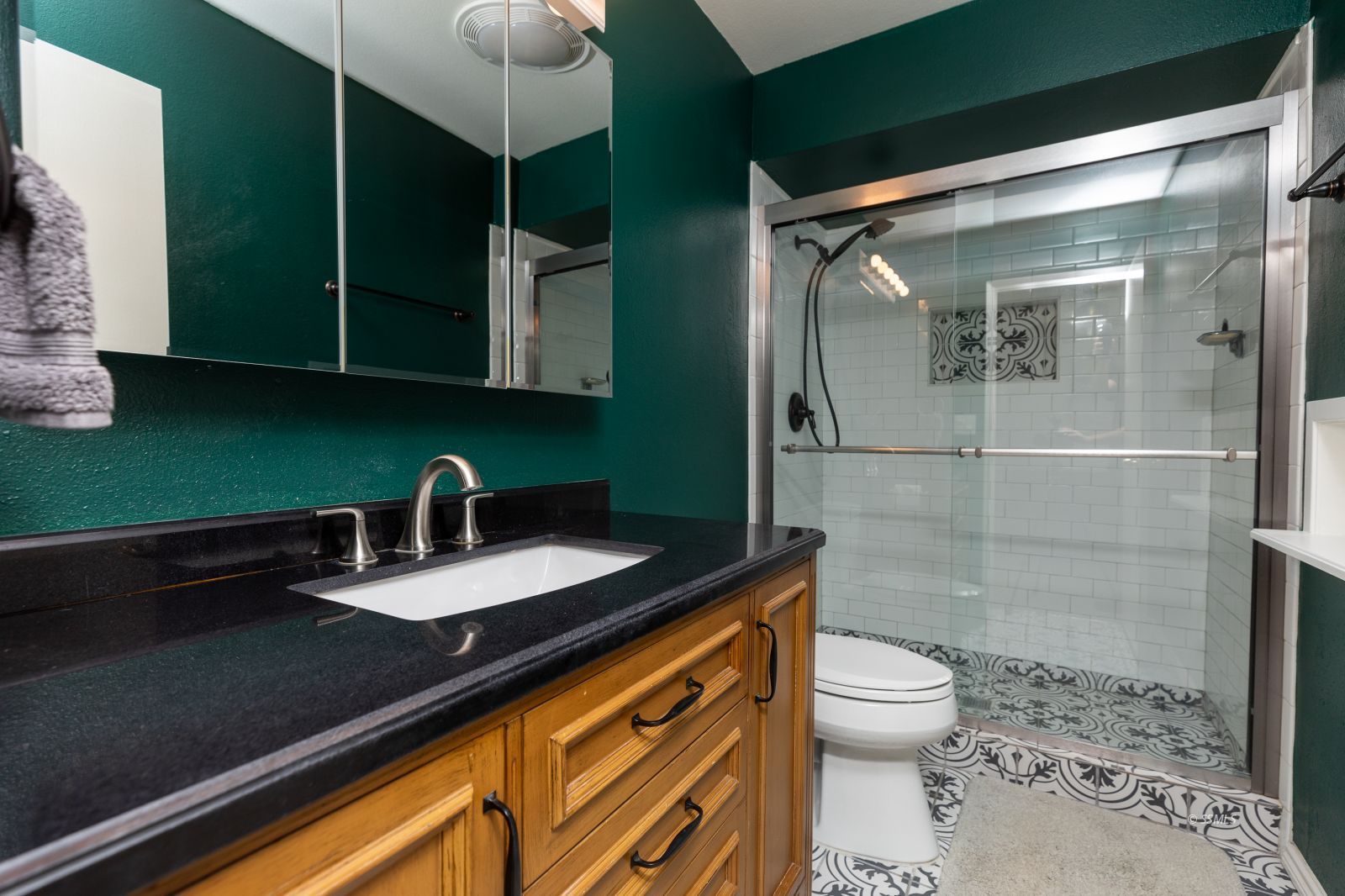 300 Mari Court Ridgecrest, CA 93555 - Photo 17 of 33 a bathroom with a granite countertop sink a toilet and shower