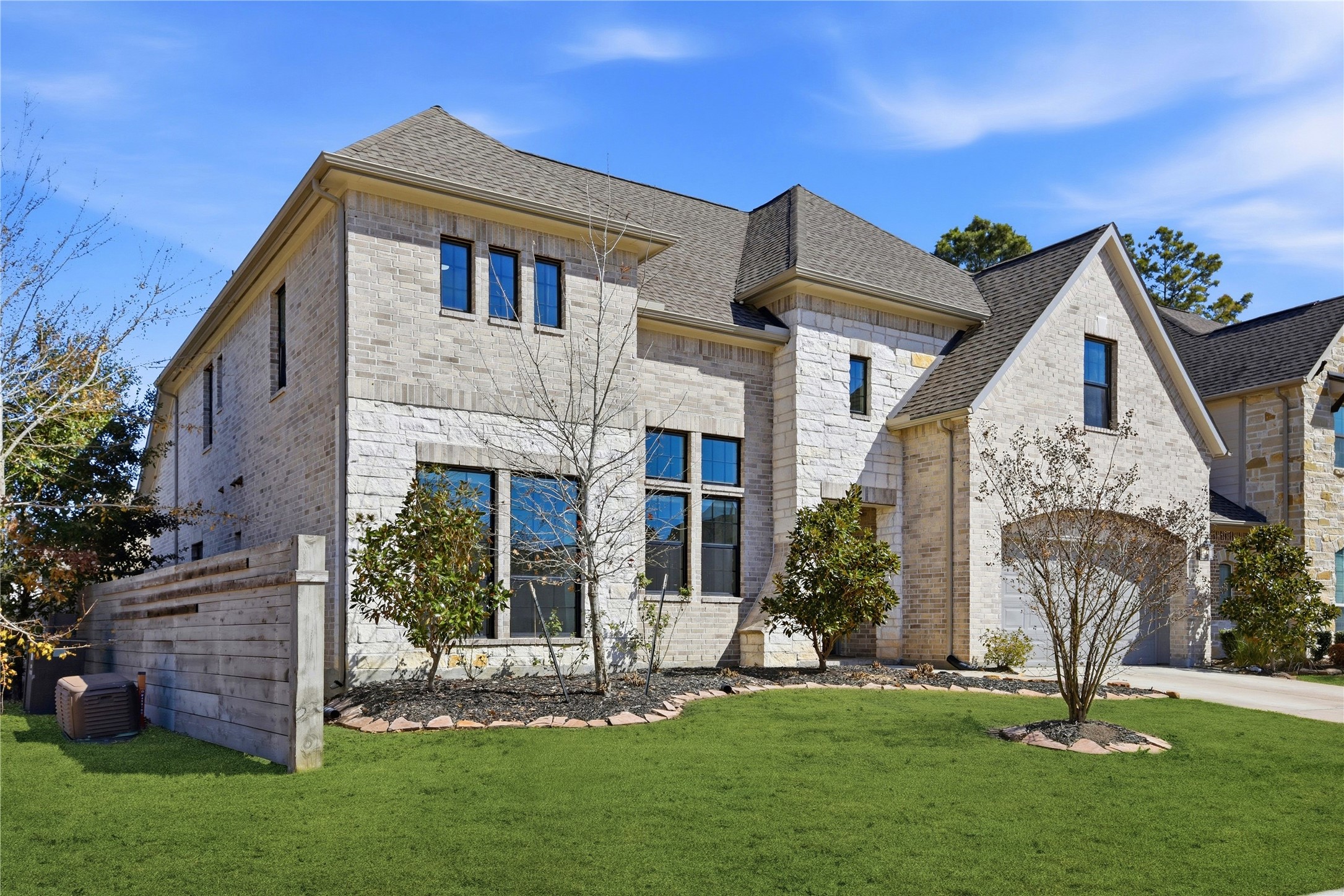 17501 Spice Merlot Lane Conroe, TX 77302 - Photo 4 of 50 a front view of a house with a garden and plants