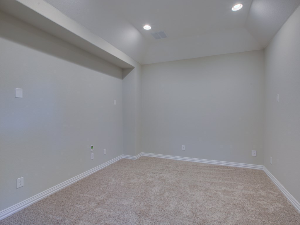 4303 Logan Ridge Drive Cedar Park, TX 78613 - Photo 16 of 24 Neutral-toned walls and plush carpet flooring complement a recessed lighting system