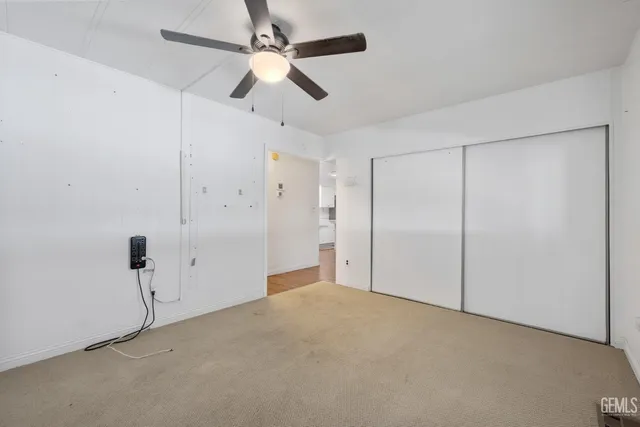 a view of a big room with chandelier fan