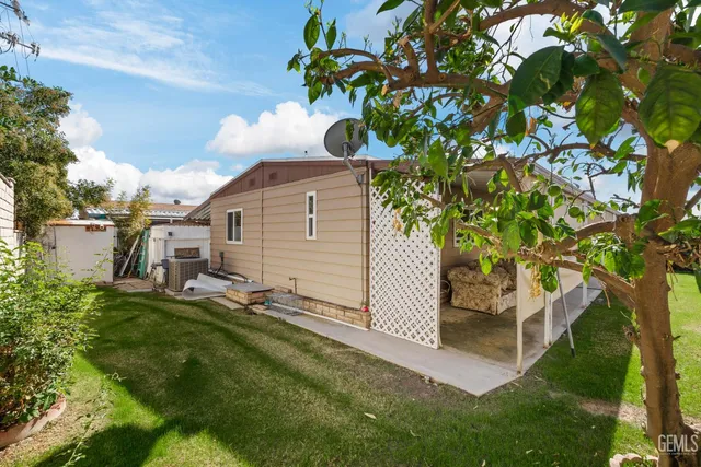 a backyard of a house with table and chairs