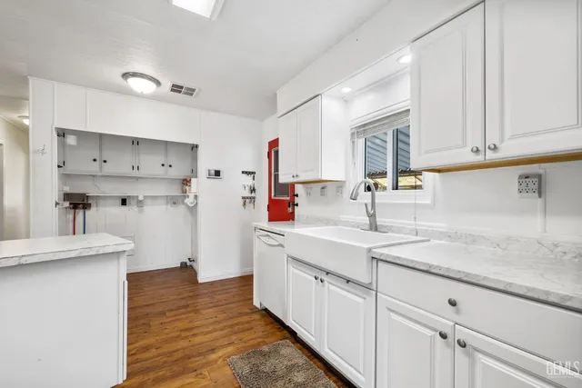 a kitchen with cabinets appliances and a counter space