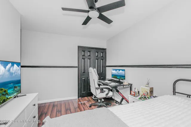 a bedroom with a bed a desk and chair