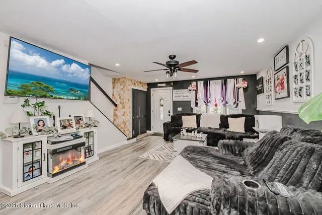 a bedroom with furniture and a flat screen tv