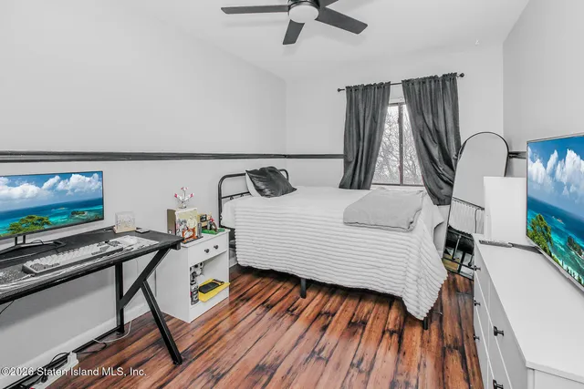 a bedroom with furniture and a flat screen tv