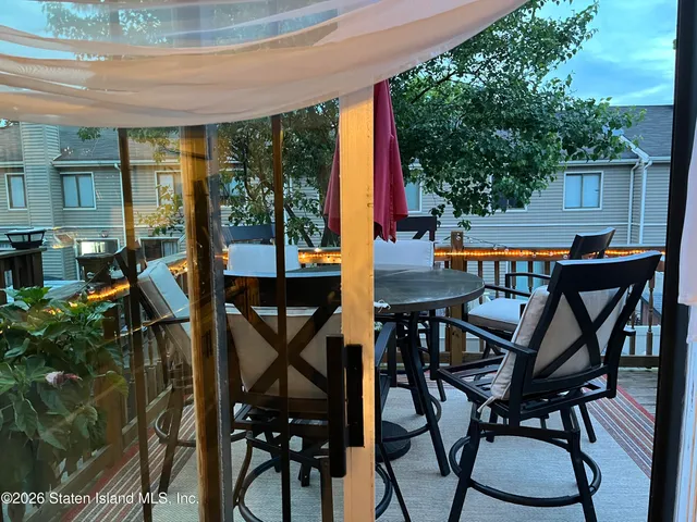 a view of a patio with table and chairs and potted plants
