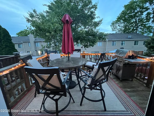 a view of a patio with a table and chairs
