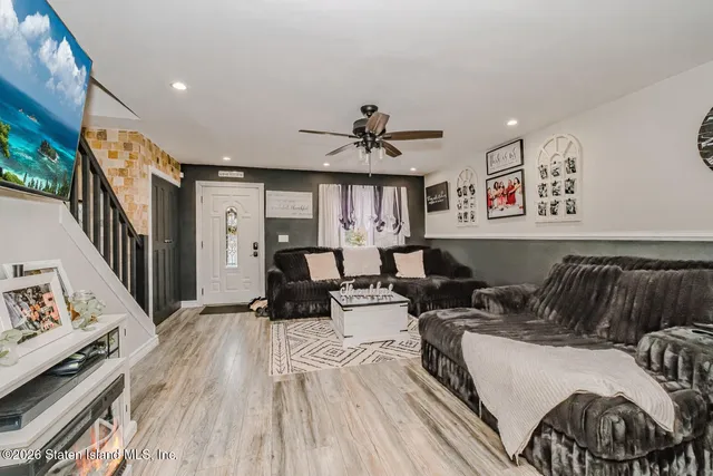 a living room with furniture and wooden floor