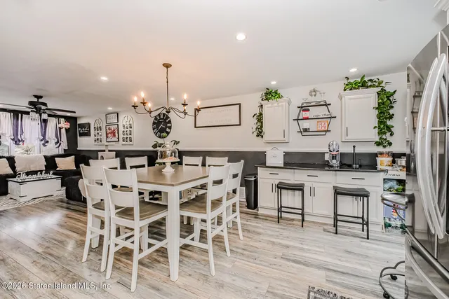 a dining room with furniture and wooden floor