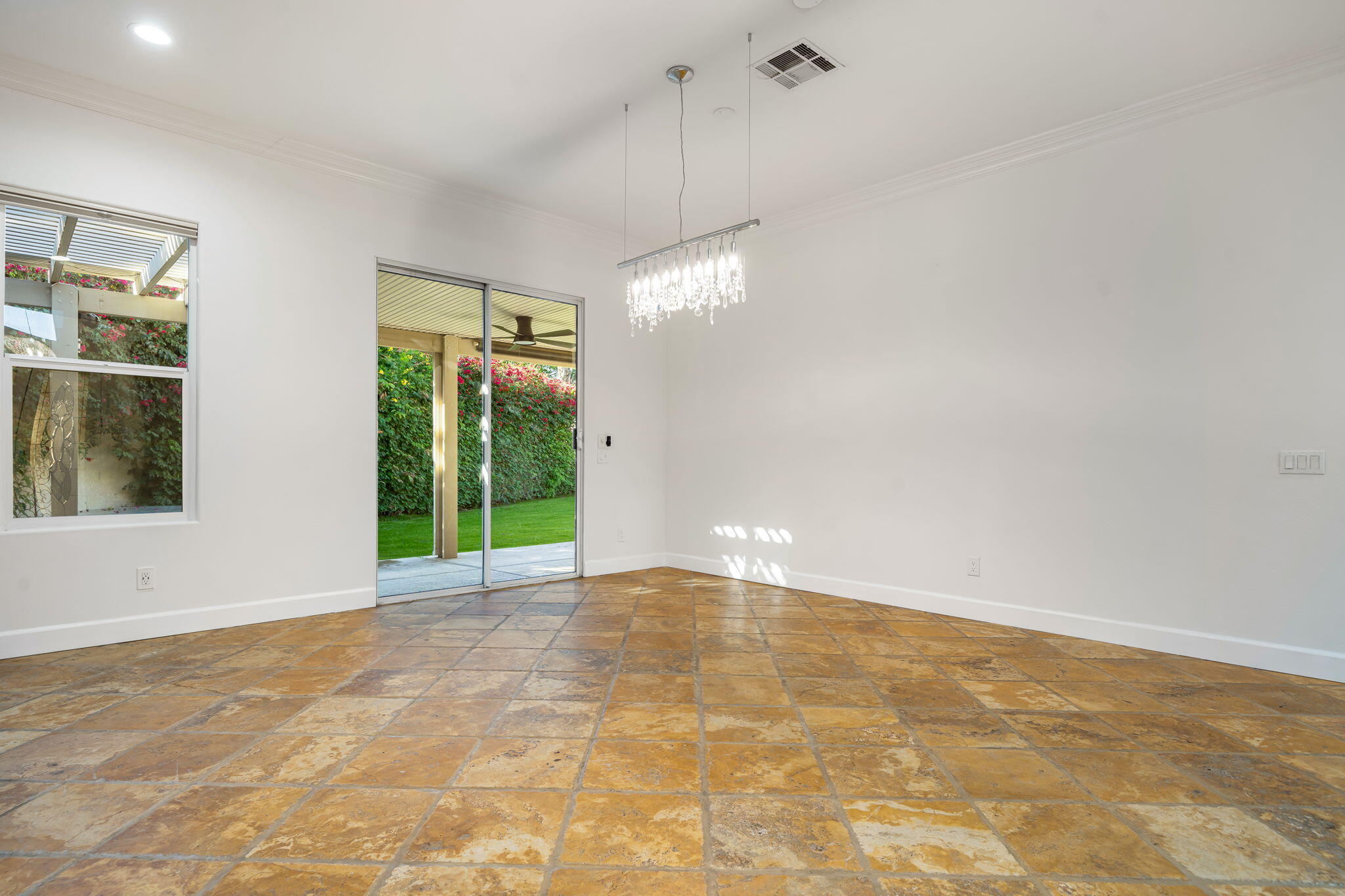 49647 Lewis Road Indio, CA 92201 - Photo 14 of 42 a view of an empty room with window and chandelier fan