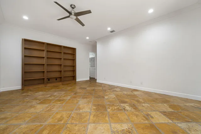 a view of an empty room with a cabinet and a window