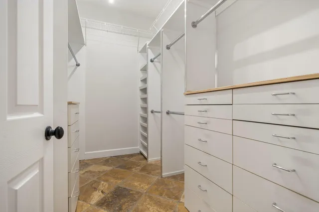 a spacious bathroom with a sink a toilet a mirror and shower