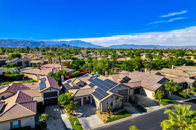 an aerial view of residential houses with outdoor space