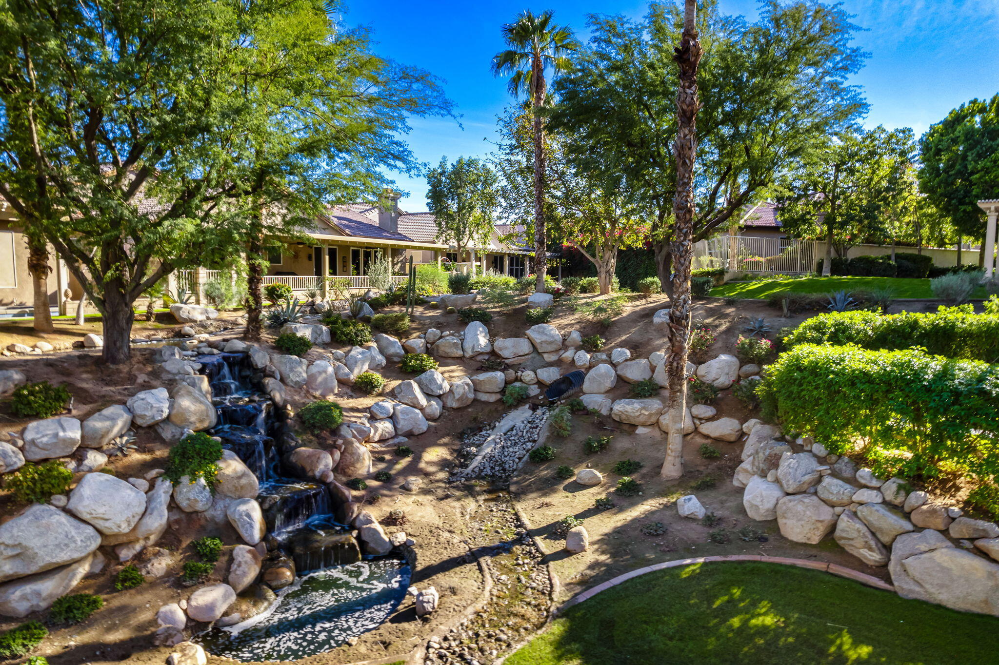 49647 Lewis Road Indio, CA 92201 - Photo 8 of 42 a picture of outdoor space with lots of plants and trees
