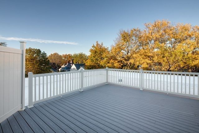 a view of a balcony with wooden fence
