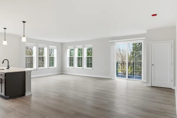 a kitchen with stainless steel appliances kitchen island granite countertop a refrigerator and a microwave