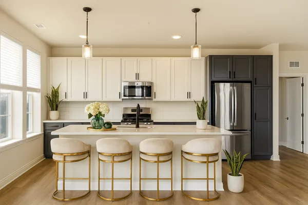 a kitchen with stainless steel appliances kitchen island granite countertop a table and chairs in it