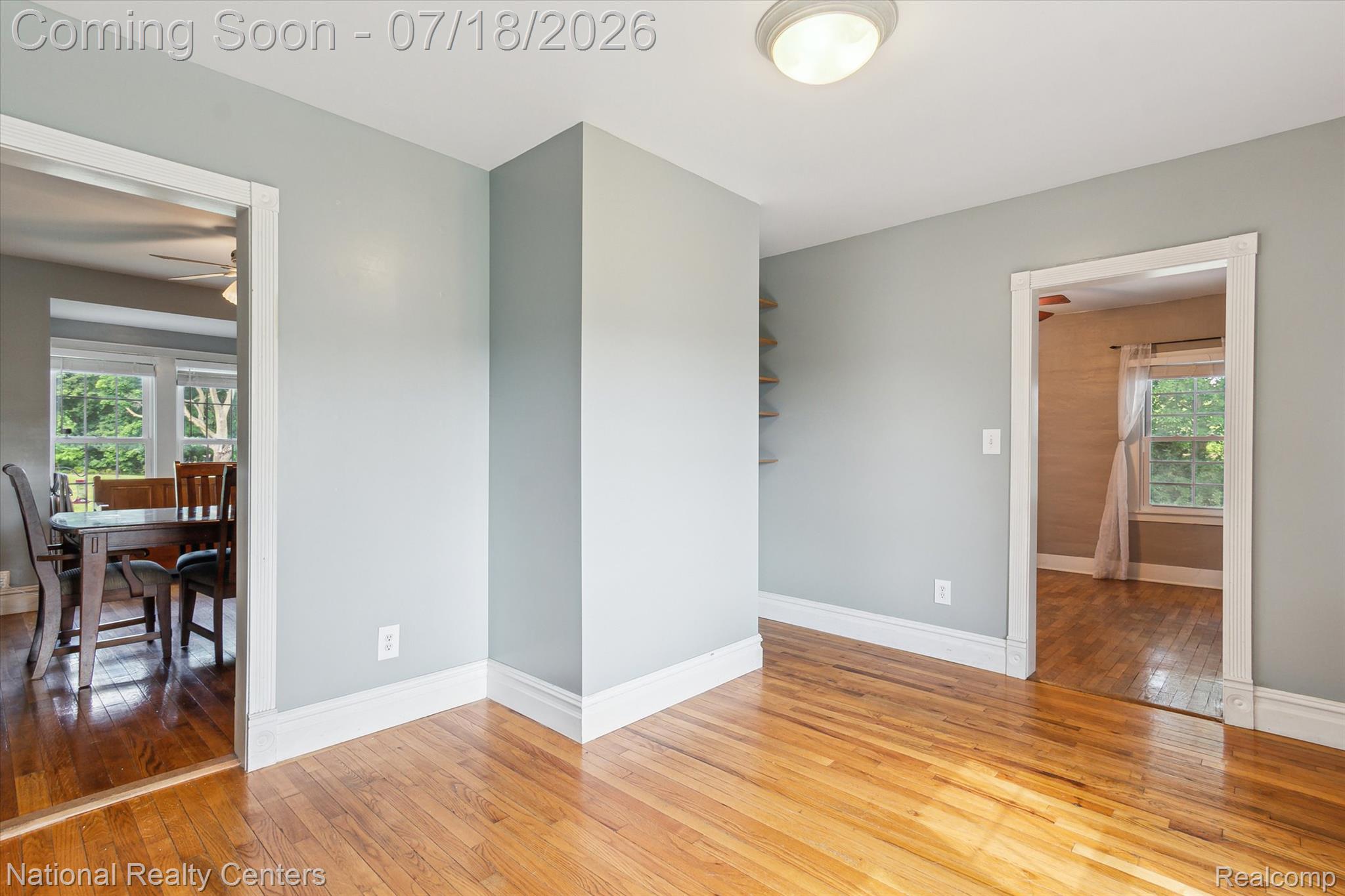 9589 Clinton Macon Road Tecumseh, MI 49286 - Photo 12 of 48 Hardwood flooring throughout, framed by white baseboards and door casings