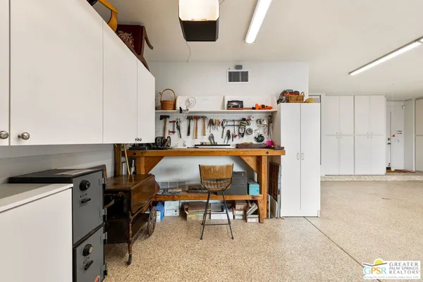 a living room with furniture a flat screen tv and kitchen view