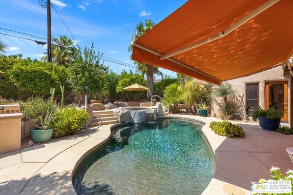 a view of a swimming pool with a patio