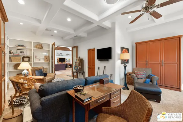 a bedroom with a large bed and a large mirror