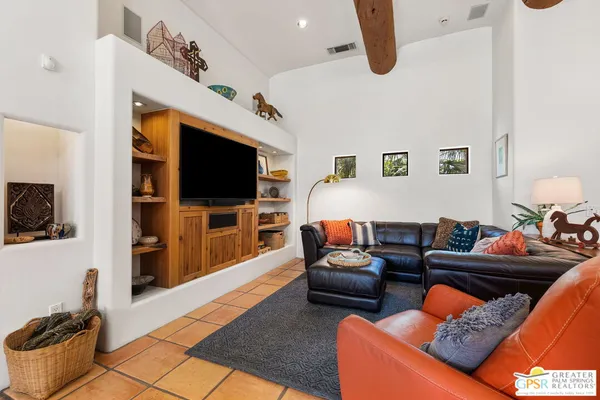 a living room with furniture fireplace and large window