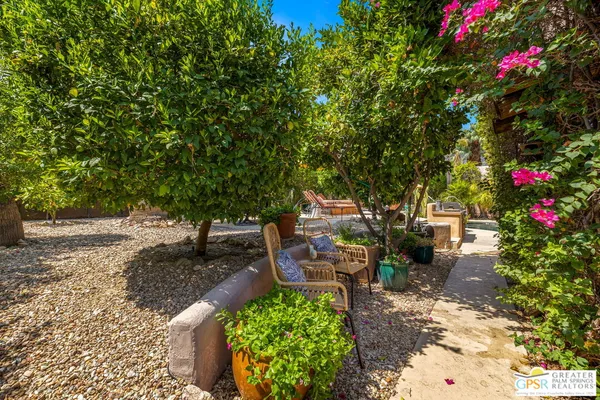 a living room with furniture fireplace and a large mirror