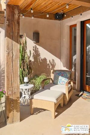 a living room with furniture a flat screen tv and a window