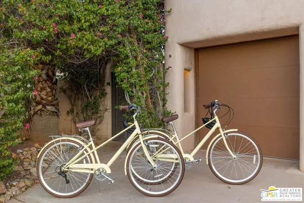 a living room with furniture a flat screen tv and a potted plant