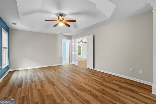 a spacious bathroom with a double vanity sink a large mirror and a shower