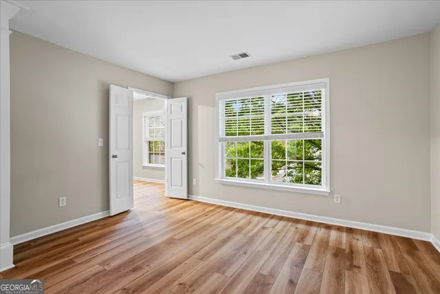 a white bath tub sitting in a bathroom next to a window