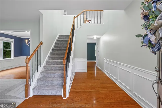 a view of entryway and hall with wooden floor