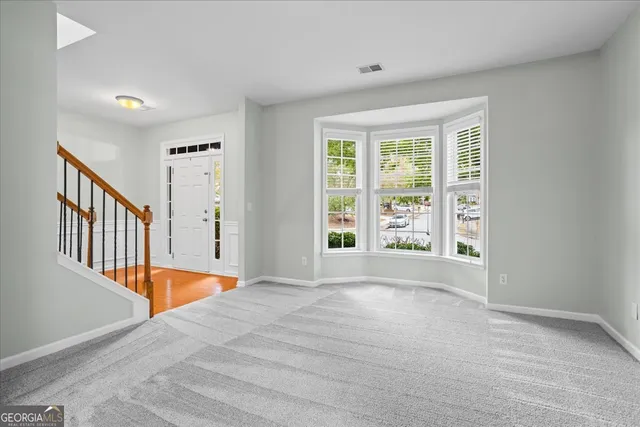 a kitchen with stainless steel appliances granite countertop a sink a stove a refrigerator cabinets and wooden floor